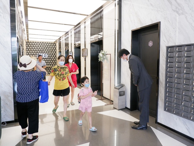 The management stood in the lobby of the building and greeted the residents